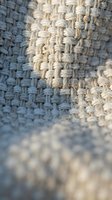Natural jute rope texture with woven knots and frayed edges creating rustic nautical maritime background for coastal home decor and craft projects.