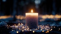Glowing candle with soft bokeh lights creating magical atmosphere against dark background, peaceful meditation and spiritual ambiance.