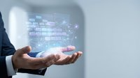 Businessman holding holographic digital interface with glowing data blocks and network connections in modern office environment for technology presentations.