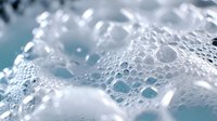 Crystal clear water bubbles and foam creating refreshing aqua splash with pristine droplets for skincare and wellness concepts.