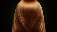 Straight copper brown hair flowing smoothly against dark background, showing healthy shine and silky texture. Professional hairstyling and beauty concept.