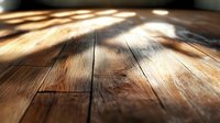 Sunlight streaming across rustic wooden floorboards creating warm highlights and deep shadows on textured oak planks. Natural home interior background.