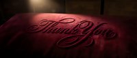 Thank you you text embossed on burgundy fabric with dramatic lighting, suitable for gratitude cards, thank you designs, and appreciation marketing materials.