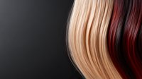 Contrasting blonde and burgundy hair strands flowing against dark background, showing smooth texture and natural movement for beauty and hairstyling concepts.