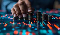African American male hand stacking coins on financial chart background with glowing red and blue market data visualization showing investment growth.