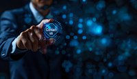 Asian businessman touching virtual contact button on digital interface with blue technology network background, modern customer service concept.