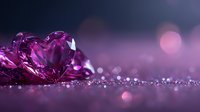 Purple crystal hearts on glittering surface with soft bokeh background in romantic pink and violet tones, creating dreamy Valentine's Day atmosphere.