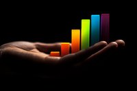 Colorful ascending bar graph floating above an outstretched palm against dark background, representing business growth, success and progress visualization.