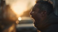 Young African American man in profile at golden hour sunset with warm bokeh lights creating peaceful contemplative mood for wellness and mindfulness concepts.