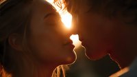 Young couple sharing intimate moment in warm golden light creating romantic silhouette for wedding and love concepts.