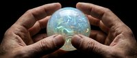Hands holding glowing crystal ball with circuit board pattern inside, representing future technology, artificial intelligence, and digital innovation for business concepts.