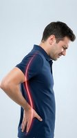 Young Caucasian man experiencing lower back pain with red highlighted spine area on white background for medical and healthcare concepts.