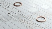 Minimalist copper rings on white circuit board pattern background for modern technology and electronics design projects.