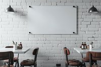 Modern cafe interior with blank glass board mockup on white brick wall, perfect for branding and menu display. Industrial pendant lamps illuminate minimalist dining space.