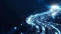 Glowing blue light trails curve through dark space with sparkling particles and lens flares creating dynamic motion effect for technology and communication designs.