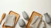 Minimalist spa wellness setup with bamboo trays, linen towels, ceramic vessels and natural bath accessories on neutral background for relaxation.
