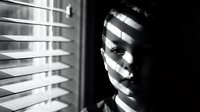 Mysterious woman with venetian blind shadows across face creating dramatic noir lighting effect in black and white photography for cinematic storytelling.