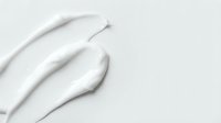 White feather quills arranged on neutral background, suitable for minimalist design, branding, wellness, and creative projects.