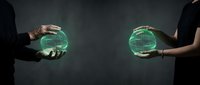 Two business professionals holding glowing green spheres representing global connectivity and digital transformation in corporate environment.