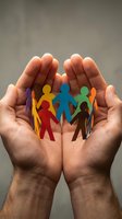 Cupped hands protecting colorful paper cutout people figures in circle representing diversity, inclusion, community support, teamwork and social unity concepts.