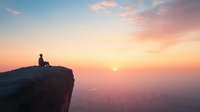 Silhouette of person sitting alone on cliff edge against dramatic sunset sky with pink clouds and misty mountain landscape below. Contemplative peaceful moment.