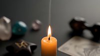 Burning candle flame creates warm ambient lighting for relaxation meditation and spiritual practices in cozy home interior setting.