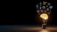 Light bulb with glowing brain and renewable energy icons floating above on dark background representing innovation and sustainable technology solutions.