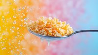 Spoonful of crunchy corn flakes with milk droplets splashing against vibrant yellow and blue gradient background, dynamic food photography for cereal advertising.