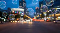 Financial market bubbles floating over blurred city lights at night representing economic volatility and investment risks in urban business district.