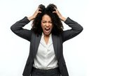 Frustrated African American businesswoman pulling hair screaming in stress isolated on white background for workplace burnout concepts.