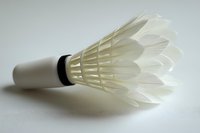 Cream synthetic badminton shuttlecock with cork base isolated on white background, ready for sports equipment design and promotional use.