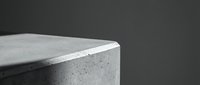 Modern minimalist concrete planter pot with speckled texture on dark background for contemporary interior design and home decor projects.