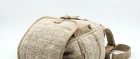 Beige linen camera bag with adjustable shoulder strap and top handle, suitable for photography equipment storage and travel.
