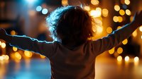 Young child with arms outstretched celebrating against warm bokeh lights background. Joyful moment of freedom and happiness in golden evening atmosphere.