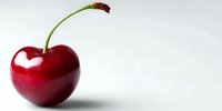 Fresh ripe cherry with stem isolated on white background, showcasing vibrant red color and glossy surface for food photography and healthy eating concepts.