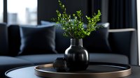 Fresh green leaves in black ceramic vase on round wooden tray against dark modern interior with sofa and decorative pillows, minimalist home decor styling.