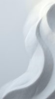 Soft white fabric with elegant flowing folds and gentle shadows creating minimalist textile background for fashion and interior design projects.