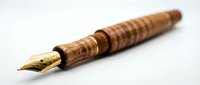 Elegant wooden fountain pen with gold nib isolated on white background for luxury writing instruments and stationery design projects.