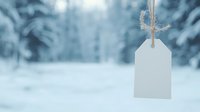 Blank white paper tag hanging on string against blurred winter forest background with snow, creating minimalist seasonal composition for copy space.