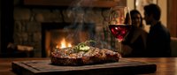 Grilled steak with red wine on wooden board, fireplace ambiance, fine dining experience for restaurants and hospitality marketing.