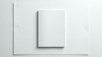 Blank white book cover mockup on minimalist background for branding and publishing design projects.
