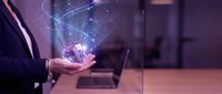 Businessman holding glowing digital globe with network connections in office workspace, representing global technology, innovation, and digital transformation for business solutions.