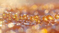 Magical golden glitter sparkles with bokeh effect on blurred background, creating dreamy festive atmosphere for holiday designs and celebrations.