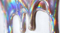 Holographic liquid dripping with rainbow iridescent effect on white background, isolated for design use on merchandise, packaging, and digital projects.