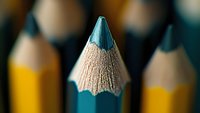 Sharp pencil tip in extreme macro photography against blurred yellow pencils background, showcasing precision and detail in education supplies.