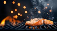 Grilled salmon fillet on barbecue with steam, smoke and flying spices. Hot coals and fire bokeh create dramatic atmosphere for food photography.