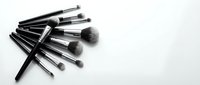 Professional makeup brushes set with black handles arranged on white background for beauty and cosmetics applications.