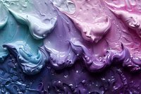 Swirling abstract pattern of mixed paint in blue, purple, and pink shades with water droplets creating dynamic texture and ethereal marble-like effect.