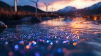 Dreamy water surface with colorful bokeh lights reflecting sunset sky, wind turbines and mountains silhouetted in background creating magical evening atmosphere.