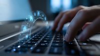 Hands typing on laptop keyboard with glowing cybersecurity shield and lock icons representing data protection and digital security in modern office.